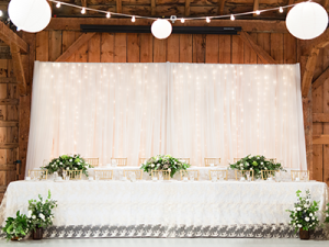 country heritage park gambrel barn wedding twinkle backdrop head table decor