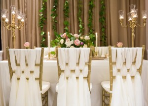 wedding decor weaved chair decor vines in backdrop candelabras