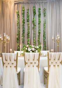 wedding decor weaved chair decor vines in backdrop candelabras